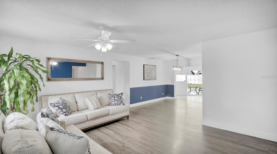 Living Room Standing From Front Door Looking To Dining Room And Florida Room
