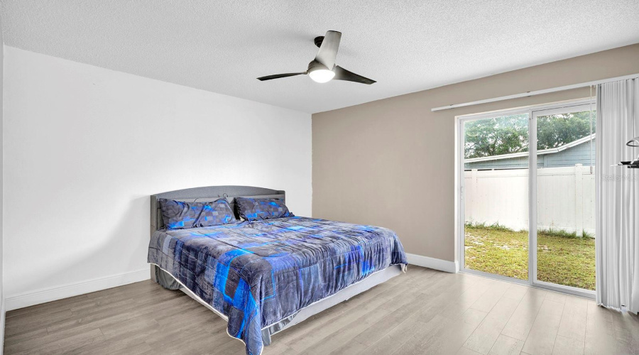 Primary Bedroom Has Slider To Backyard