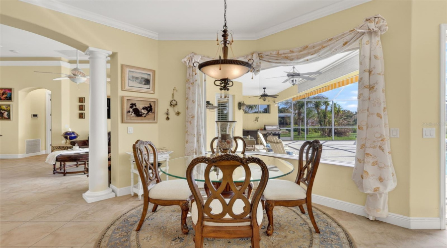 The Sunny Breakfast Nook Offers The Perfect Place To Enjoy Morning Coffee While Overlooking The Pool, Lanai, And Scenic Acreage Beyond.