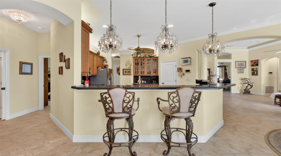 The Expansive Breakfast Bar And Open-Concept Layout Create An Ideal Setting For Entertaining, With Effortless Flow Between The Kitchen And Living Areas.