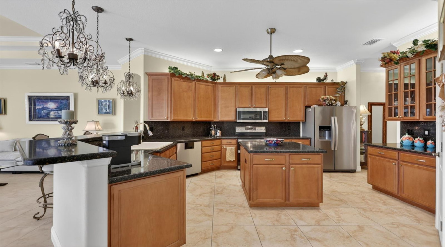 The Oversized Kitchen Is Designed For Both Everyday Living And Entertaining, Featuring Extensive Cabinetry, Generous Prep Space, A Center Island, And Abundant Storage.