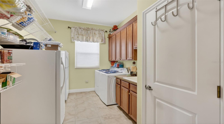 The Spacious Laundry Room Offers Abundant Cabinetry, Countertop Workspace, And Additional Storage To Keep Daily Routines Organized.