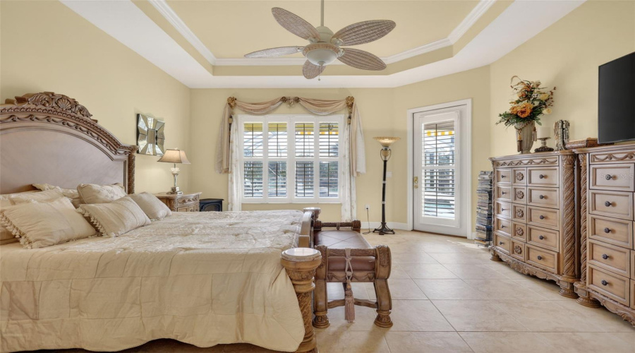 The Generously Sized Primary Suite Features Tray Ceilings, Plantation Shutters, Private Lanai Access, And Plenty Of Room To Relax And Unwind.