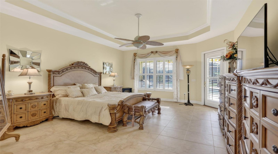 The Spacious Primary Bedroom Offers Elegant Architectural Details, Abundant Natural Light, And Direct Access To The Outdoor Living Area.