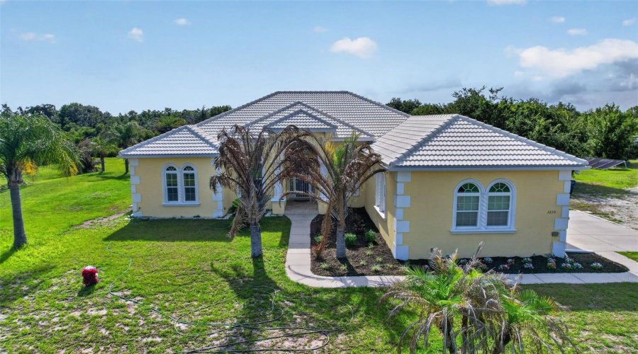 Impressive Custom Residence Showcasing Barrel Tile Roofing, Expansive Grounds, And A Thoughtfully Designed Floor Plan With Superior Living Space.
