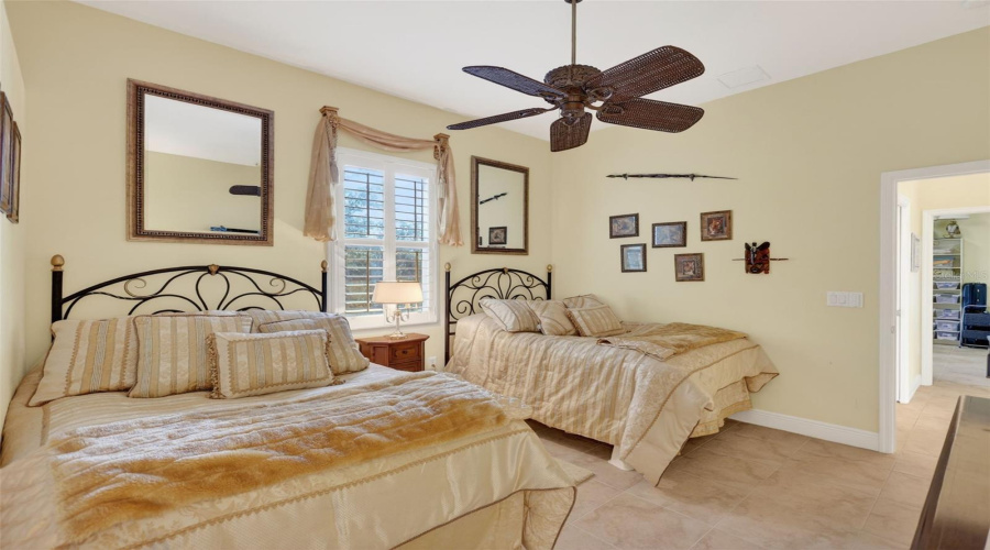 The Spacious Guest Bedroom Comfortably Accommodates Multiple Sleeping Arrangements While Offering Generous Closet Space And Charming Architectural Details.