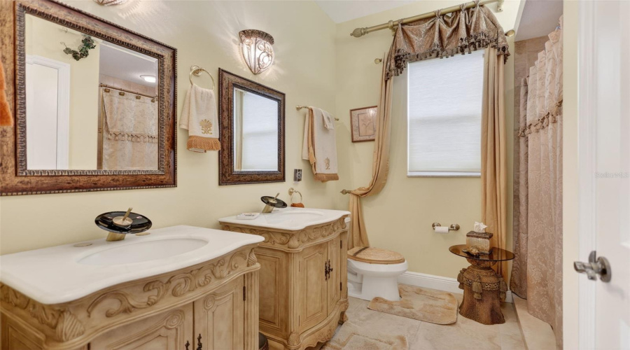Elegant Fixtures And Quality Finishes Create A Welcoming Guest Bath Designed With Both Style And Practicality In Mind.