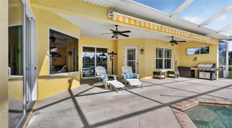 The Expansive Covered Lanai Creates The Perfect Setting For Outdoor Entertaining, Complete With Ample Seating Areas, Ceiling Fans, And Convenient Access To The Outdoor Kitchen.
