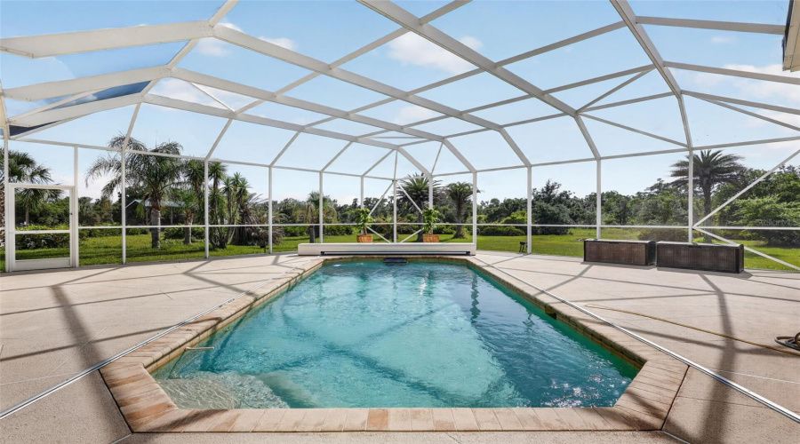 The Screened Pool Enclosure Frames Picturesque Views Of The Surrounding Landscape While Providing An Exceptional Private Outdoor Retreat.