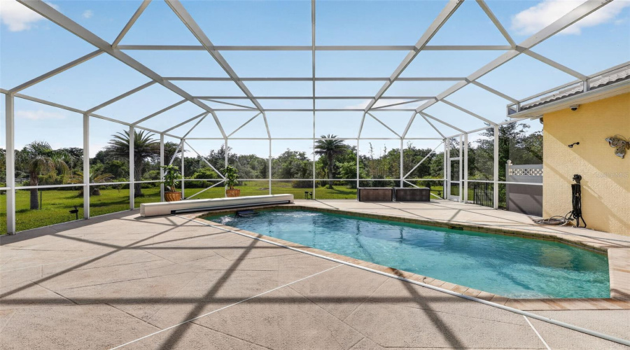 Surrounded By Mature Landscaping And Open Green Space, The Heated Saltwater Pool And Oversized Lanai Provide The Perfect Setting For Relaxation And Entertaining.