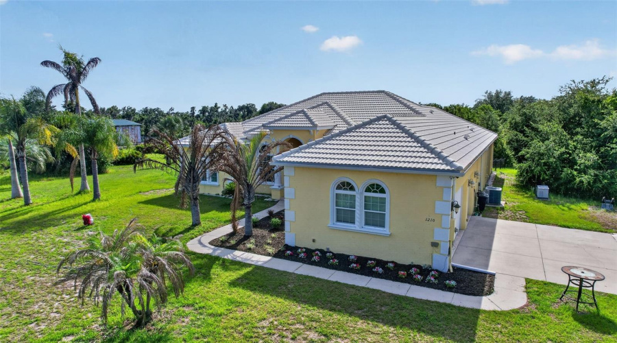 The Home'S Elegant Mediterranean-Inspired Architecture, Tile Roof, And Lush Landscaping Create Exceptional Curb Appeal On This Private Multi-Acreage Homesite.