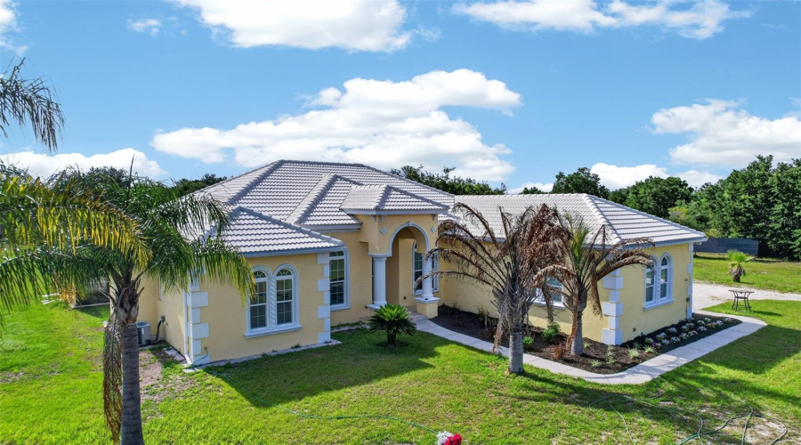 Architectural Details, Mature Palms, And A Grand Entryway Contribute To The Home'S Impressive Presence And Timeless Design.