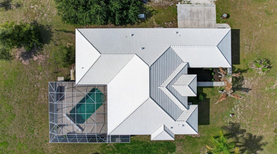 An Aerial Perspective Highlights The Home'S Thoughtfully Designed Floor Plan, Expansive Screened Pool Enclosure, And Generous Acreage Setting.