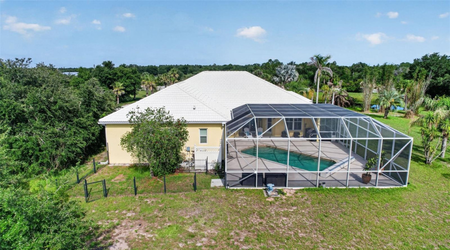 An Aerial Perspective Showcases The Expansive Screened Pool Enclosure, Adjacent Fenced Dog Run, And The Home'S Exceptional Privacy On Over Six Acres.