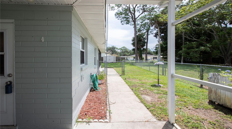 Side Yard Leading To Fenced Back Yard.