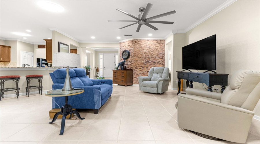 171/2 X 171/2 Tile Flooring, Spacious Living Room Area, High Ceiling, Modern Ceiling Fan, Modern Lightings. Bricks Wall Focal Point Custom.