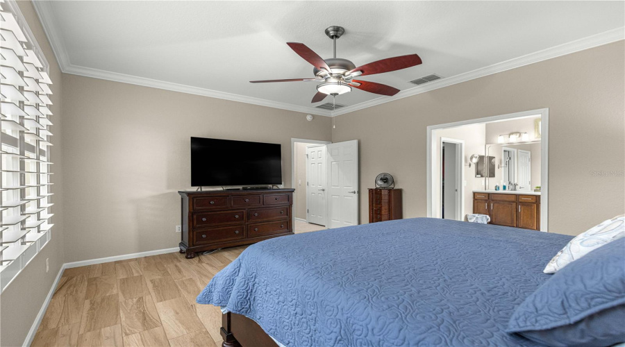 Primary Bedroom Modern Ceiling Fan, Tile Flooring, Crown Molding