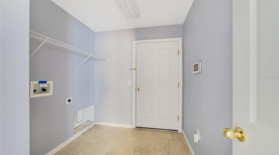 The Laundry Room, Conveniently Located Near The Main Living Area And The Secondary Bedrooms, Has A Built-In Storage Shelf To Keep Things Neat And Tidy.