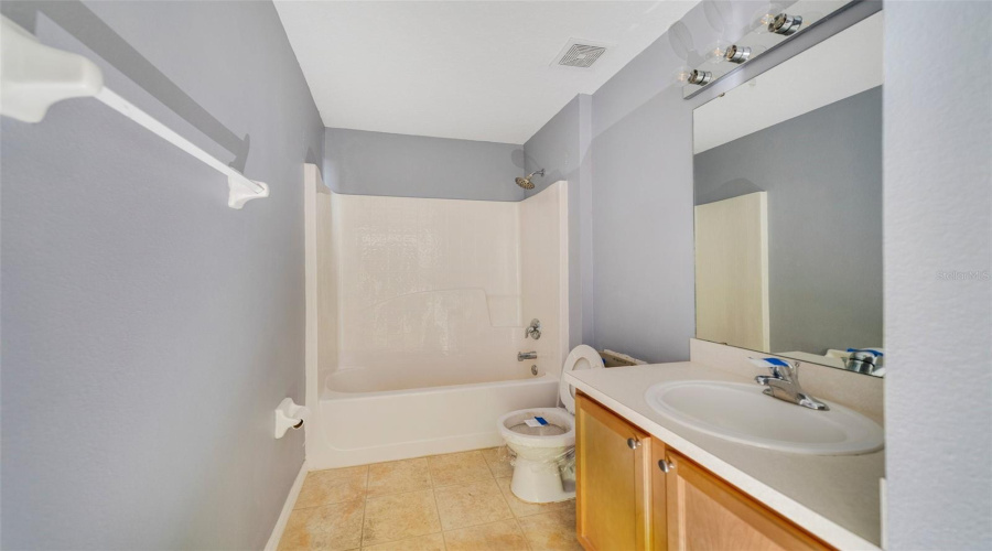 On The Opposite Side Of The Home, Two Additional Bedrooms Share A Full Bath, Ideal For Family Or Guests.