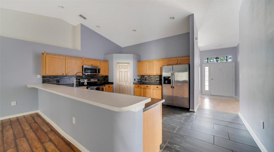 A Kitchen Breakfast Bar Includes Space For Counter-Height Seating, Perfect For Casual Dining Or Conversation.