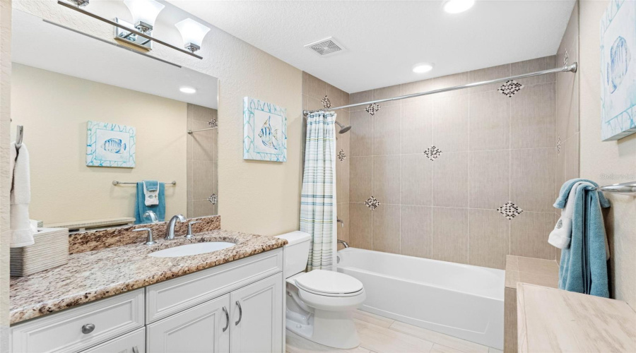 ... Guest Bathroom  - 11.9 X 6.1... Tub With Shower - Built In Tiled Bench Seat. Guest Bathroom Can Be Accessed From Hallway And Or Guest Bedroom.
