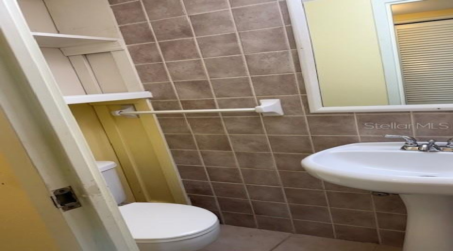 Half Bath Located Between Dining Area And Kitchen