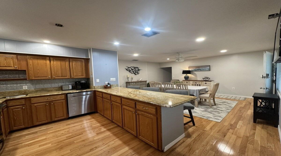 Kitchen And Island Bar With Attached Dinning Area.
