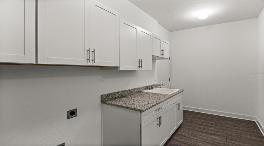 Laundry Room With Cabinets, Sink And Granite Countertop