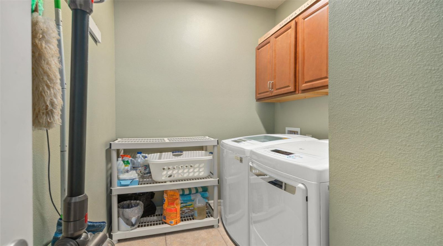 Laundry Room With Upper Cabinetry. The Washer And Dryer Are Included.