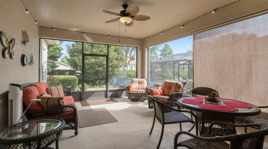 The Screened Under Roof Lanai Offers A Great View Of The Rear Yard And Has Roller Shades On One Side.