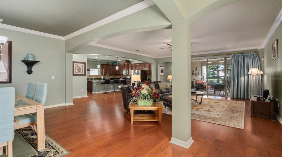 Entering To A Spacious Open Floor Plan With Engineered Hardwood, Crown Molding And A View Of The Lanai