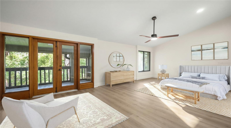 Virtually Staged Primary Bedroom With French Doors To Private Balcony
