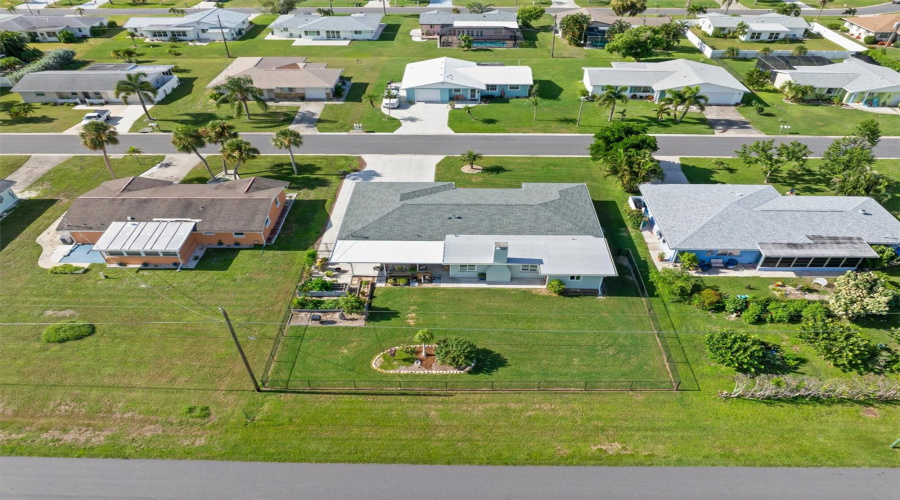 Showing Off The Fenced In Area And No Home Behind