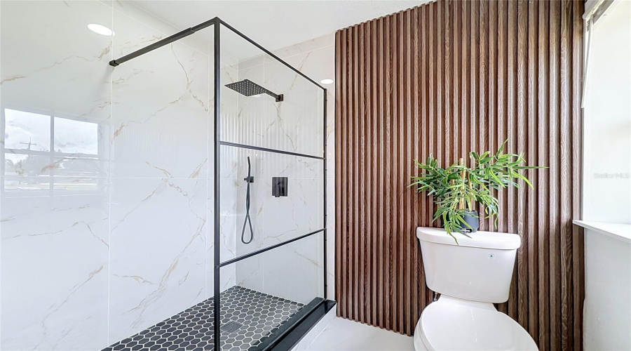 Primary Bathroom With A Modern Walk-In Rainfall Shower.