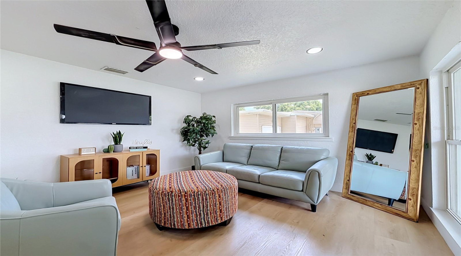 Natural Light Fills The Welcoming Living Room.