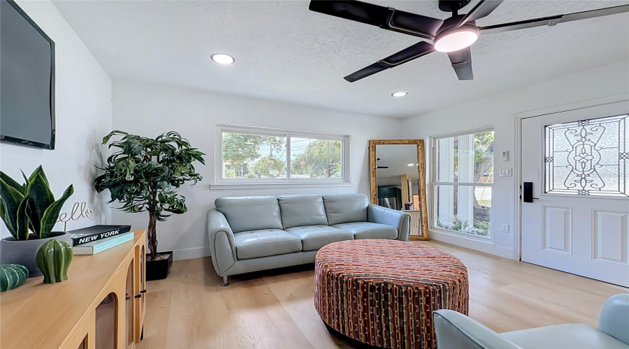Bright Living Room With Modern Lighting And Updated Flooring.