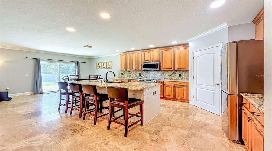 Kitchen With Granite And Island Bar