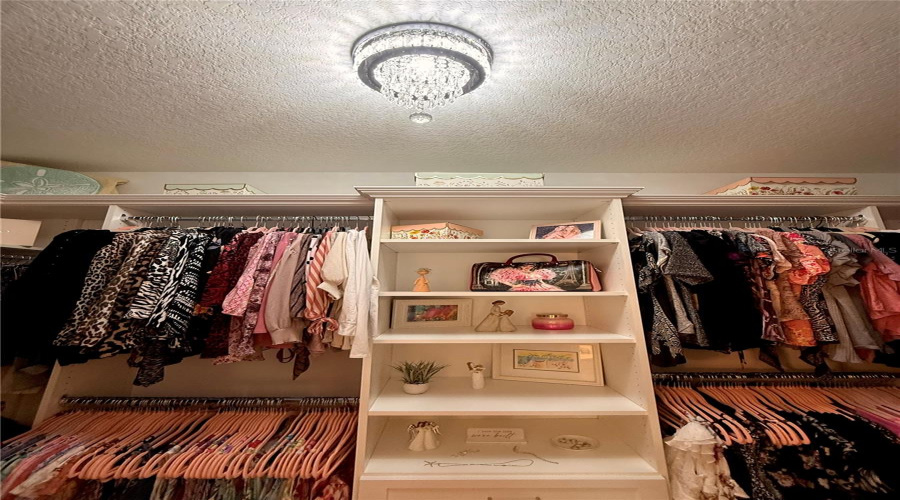 Custom Primary Walk-In Closet By Closets By Design With Crystal Chandelier