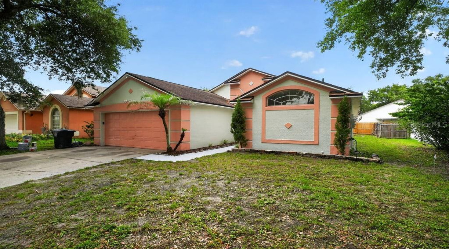 Wide View Of The Front Elevation With An Attached Two-Car Garage.