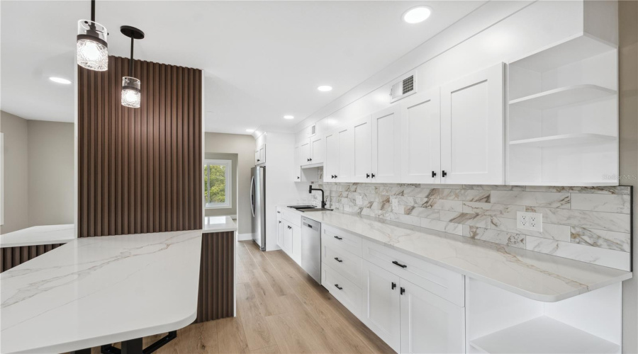 Stunning Kitchen With Tons Of Cabinets, Stone Counters And Backsplash