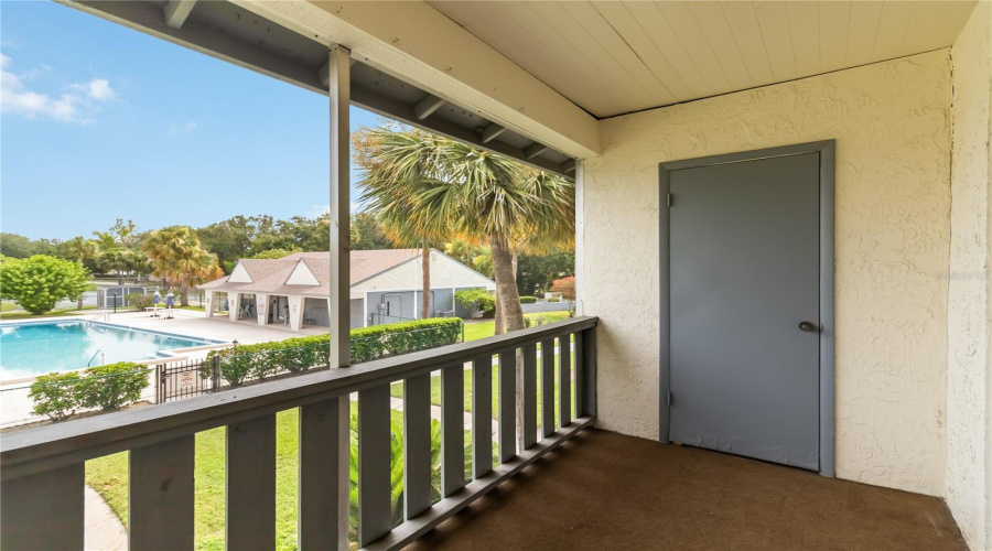 Rear Balcony-Style Porch With View Of Pool And Clubhouse