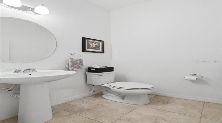 A Conveniently Located Guest Half Bath Adds A Thoughtful Touch For Visitors While Keeping The Home’s Private Spaces Separate.