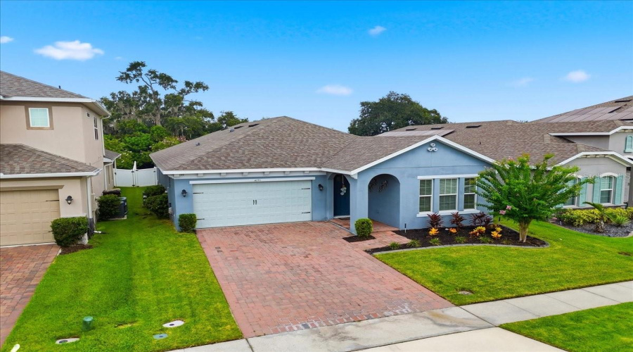 An Elevated View Showcases The Home’s Distinctive Architecture, Pristine Curb Appeal And Beautifully Landscaped Setting.