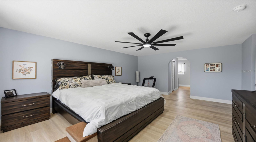 Primary Bedroom With Hallway To Closets And En-Suite Bath