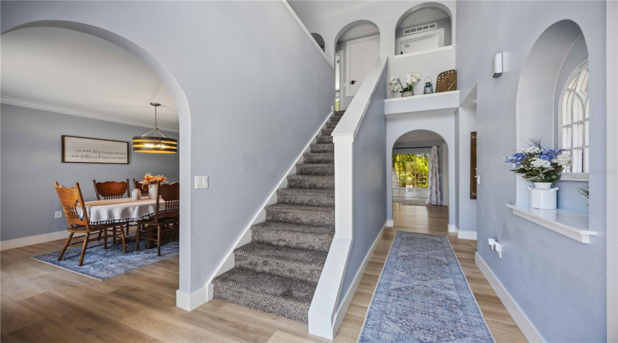 Entry View With Arched Entrance To Dining Room