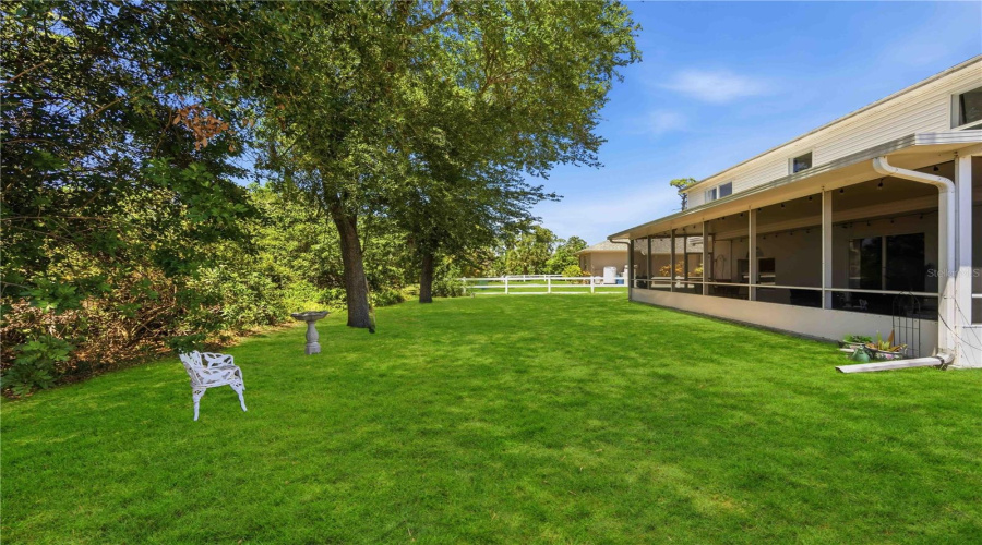 Rear View Of Home Featuring Huge Screened Porch And Room For A Pool