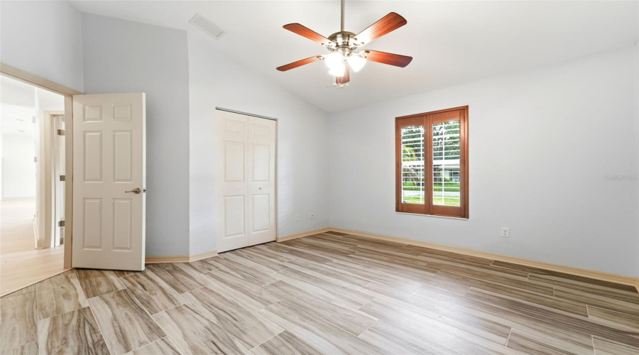 Bedroom Two With Built In Closet And Plantation Shutters.