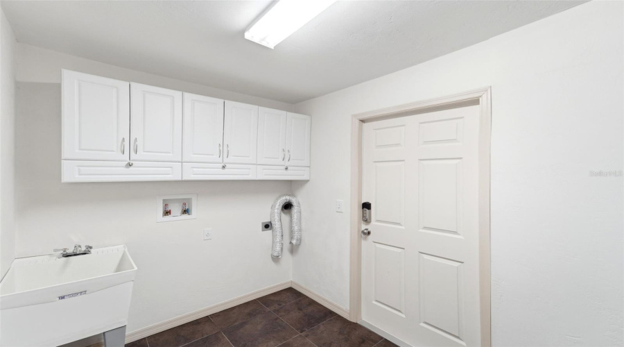 Functional Laundry Room With Additional Cabinetry For Extra Storage.