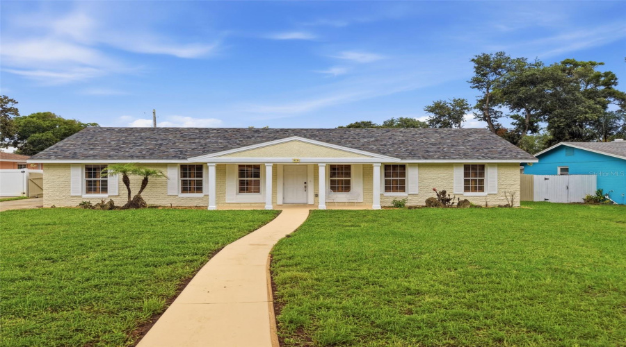 Welcome Home To 59 Crestwood Circle—Where Timeless Curb Appeal Meets Modern Florida Living.