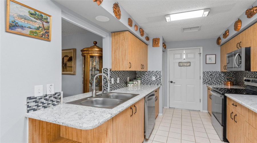 Functional Kitchen Featuring Quartz Countertops And Generous Cabinet Space.